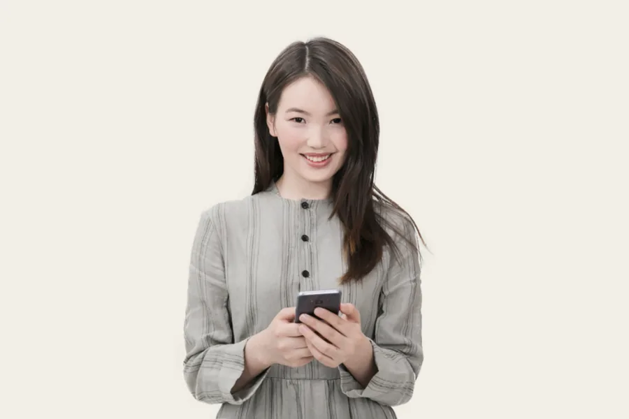 Person smiling while using their phone